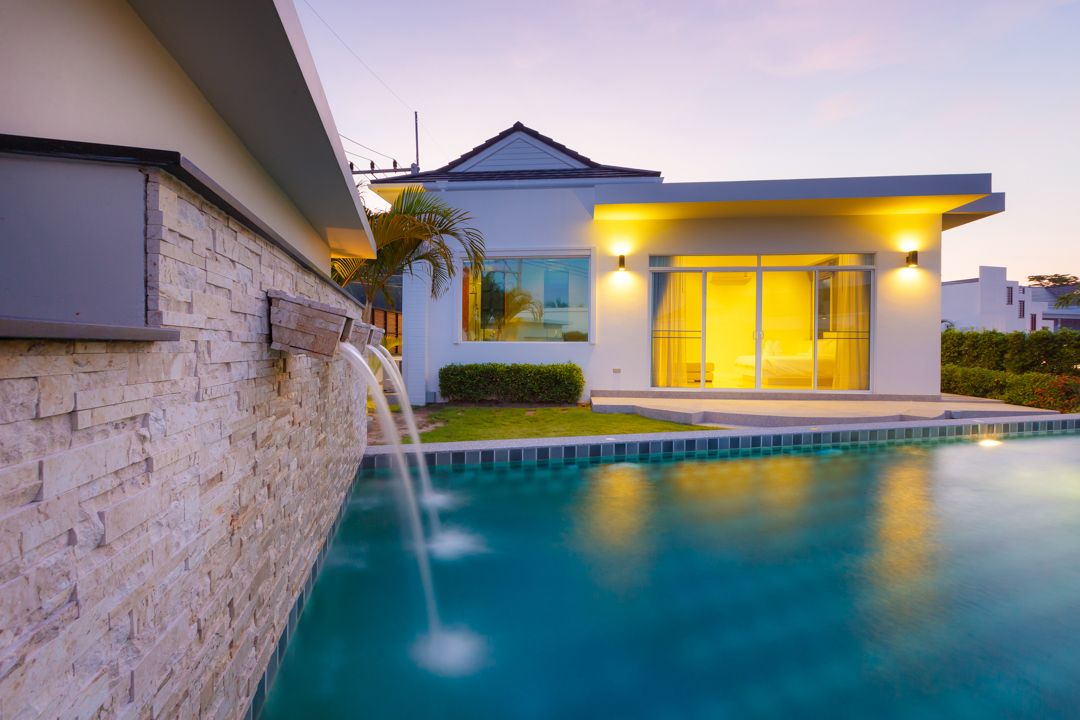 Sea Breeze Pool Villa and its private pool at dusk
