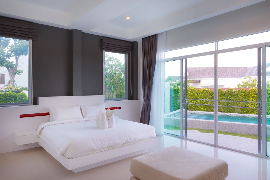 Primary suite with king bed and pool view
